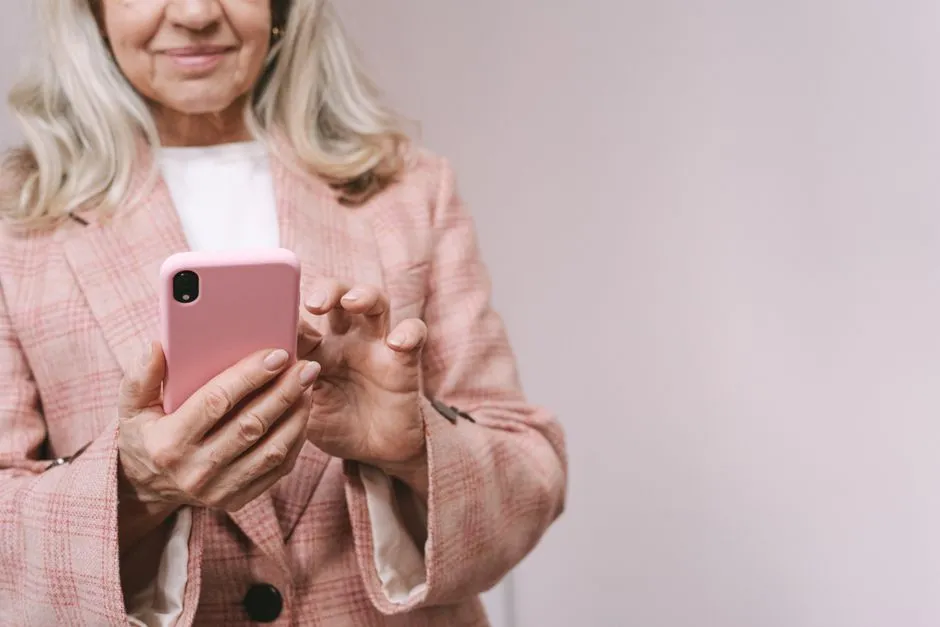 Older adult using a smartphone, illustrating the kind of everyday mobile use a Lifeline-subsidized phone supports